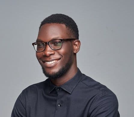 man in black dress shirt wearing black framed eyeglasses